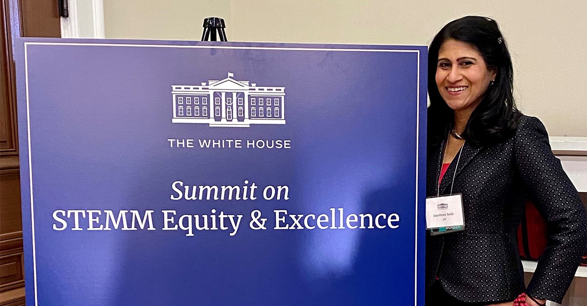 Dr. Jayshree Seth poses next to the White House STEMM Equity & Excellence summit sign.